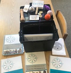 Various RCL program materials include a workbook, yarn, and other crafting tools.